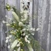 Neutral wall candle holder floral arrangement